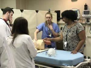 Resident Loren Guzman teaches medical students in the anesthesiology lab