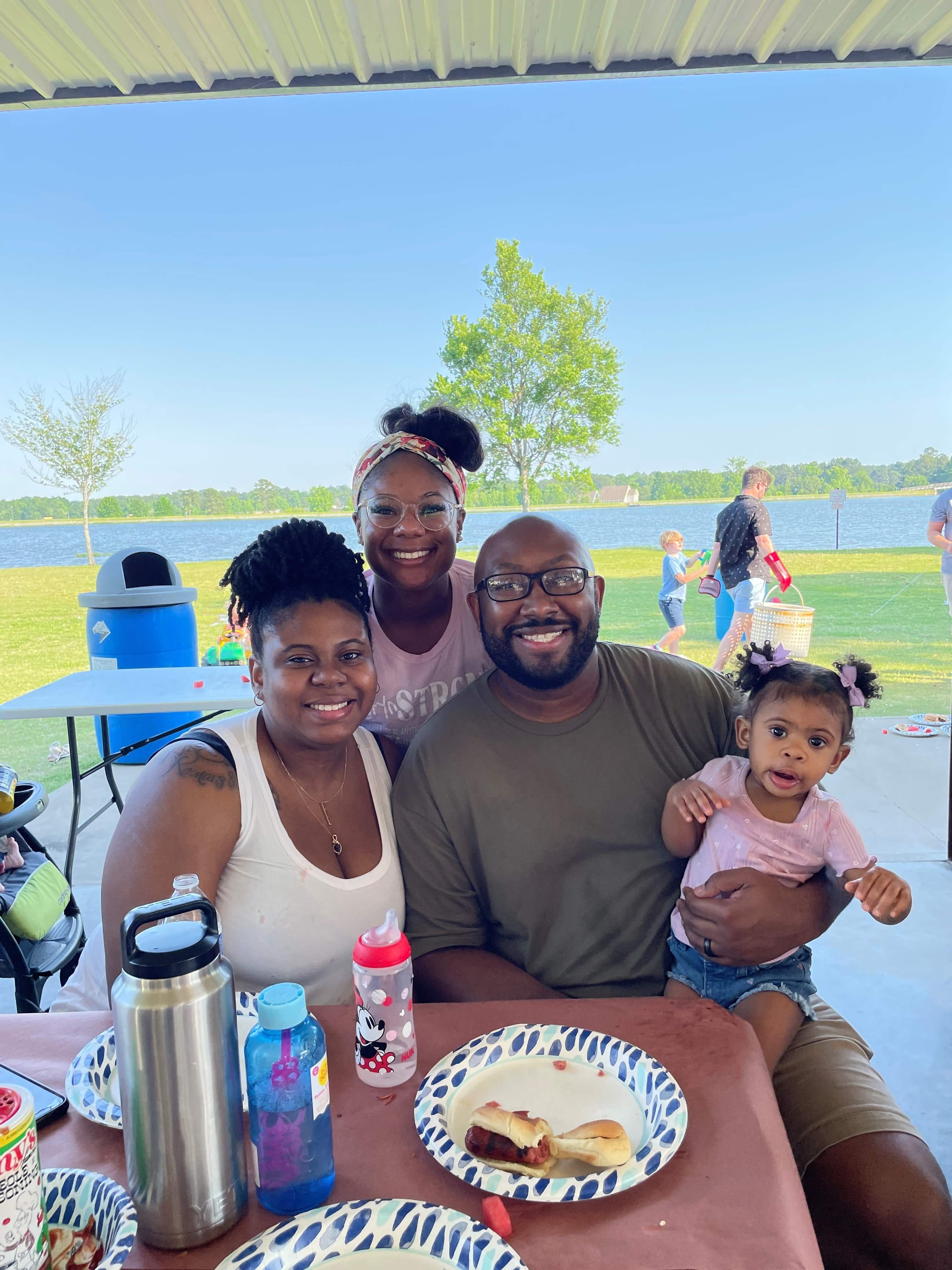 resident with his family at a picnic table