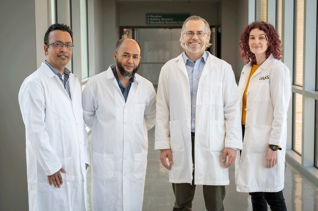 Dr. Eoff and team, posing in a hallway in white coats