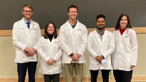 Photo of student wearing their new white coats