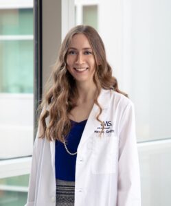 Photo of Haven Griffin in a white coat.