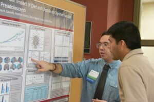 A student presenting their poster