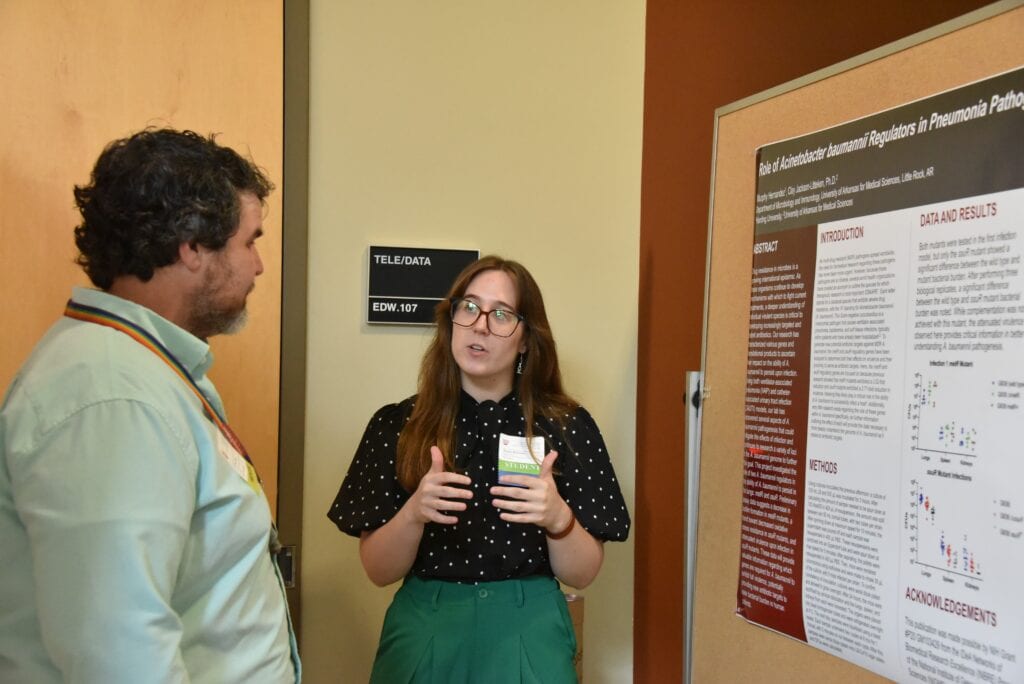 A student presenting their poster