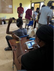 Group doing hearing tests in a classroom in Sierra Leone