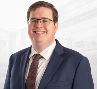 Smiling portrait of Kirk West, PhD in suit and tie.