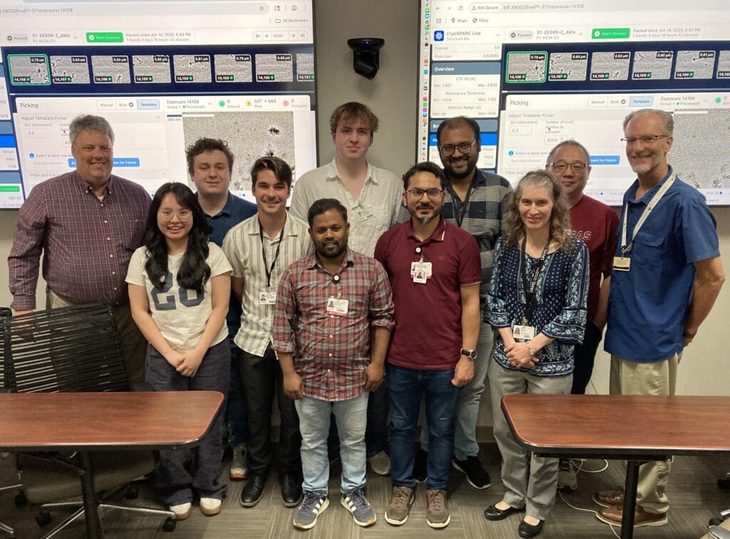 Group picture of Workshop participants in front of screens