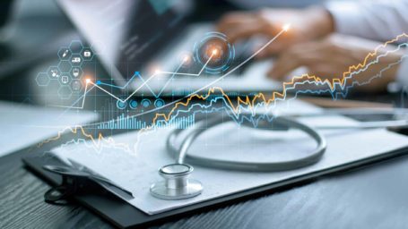 Healthcare business graph data and growth, Stethoscope with doctor's health report clipboard on table, Medical examination and doctor analyzing medical report on laptop screen.
