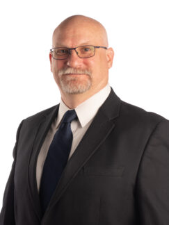Charles Brown middle aged man with glasses in dark suit