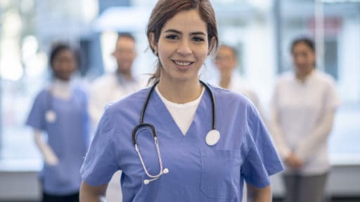 APRN stands in front of colleagues
