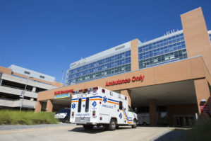 Exterior of the Emergency Department at the UAMS Medical Center. An ambulance is pulling into the drive.