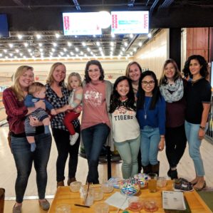 Female residents and faculty posing at a bowling alley