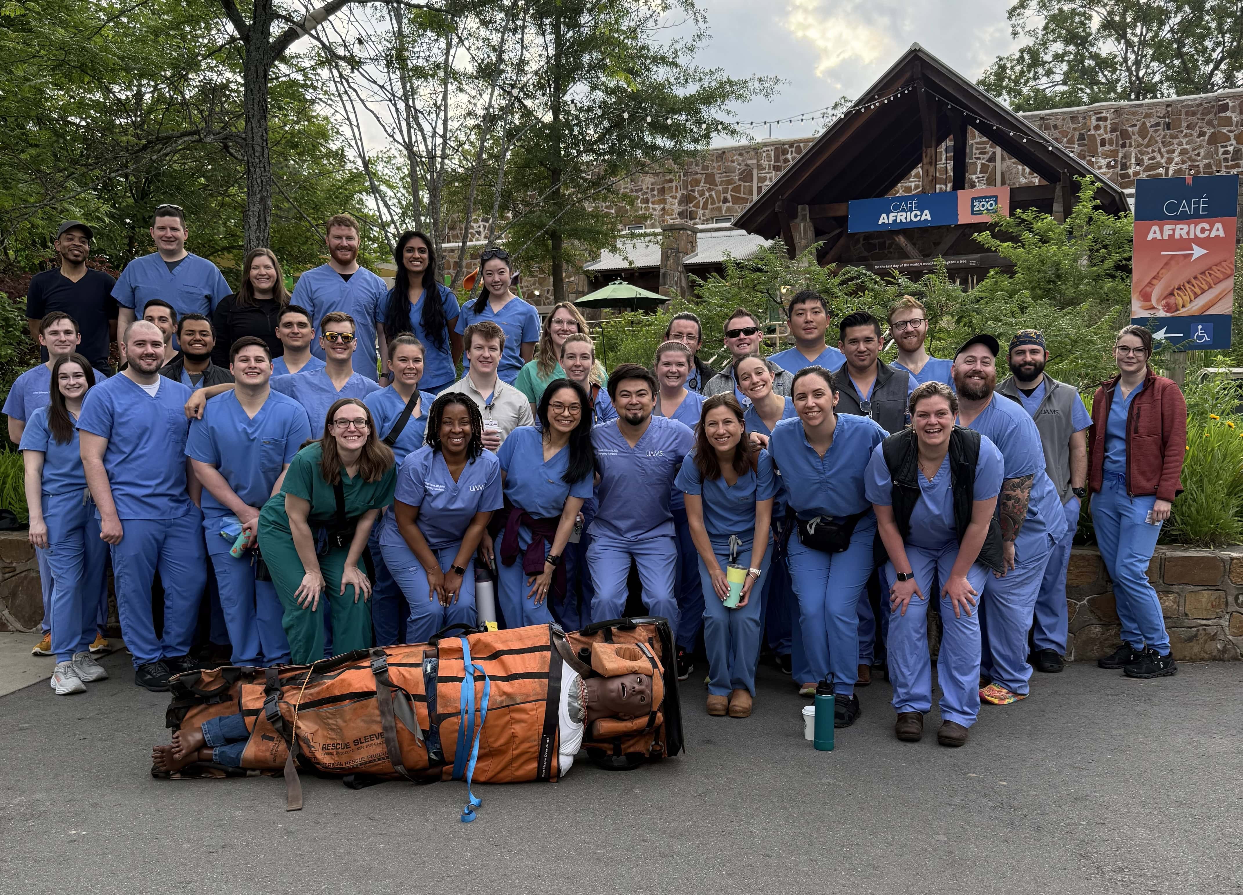 Group photo of EM residents posing outdoors