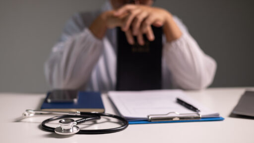 Doctor prays for the health of the person under their care, as medicine, nurses, and health care at the hospital work together to fight the disease. doctor, pray, health, person, medicine, care.