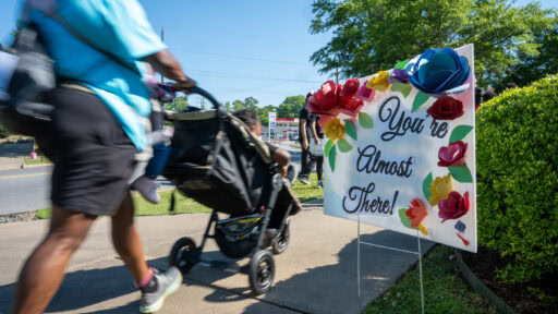 Person pushing a stroller at the be a part of the cure walk