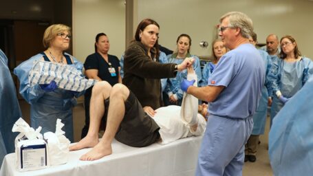 Dr. Frazier shows a class of physicians how to splint an arm.