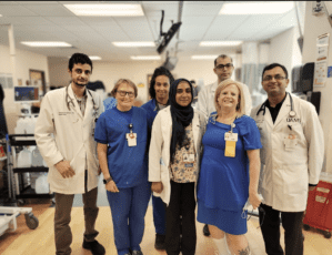 group of nephrology fellows posing with the dialysis crew in a clinical setting