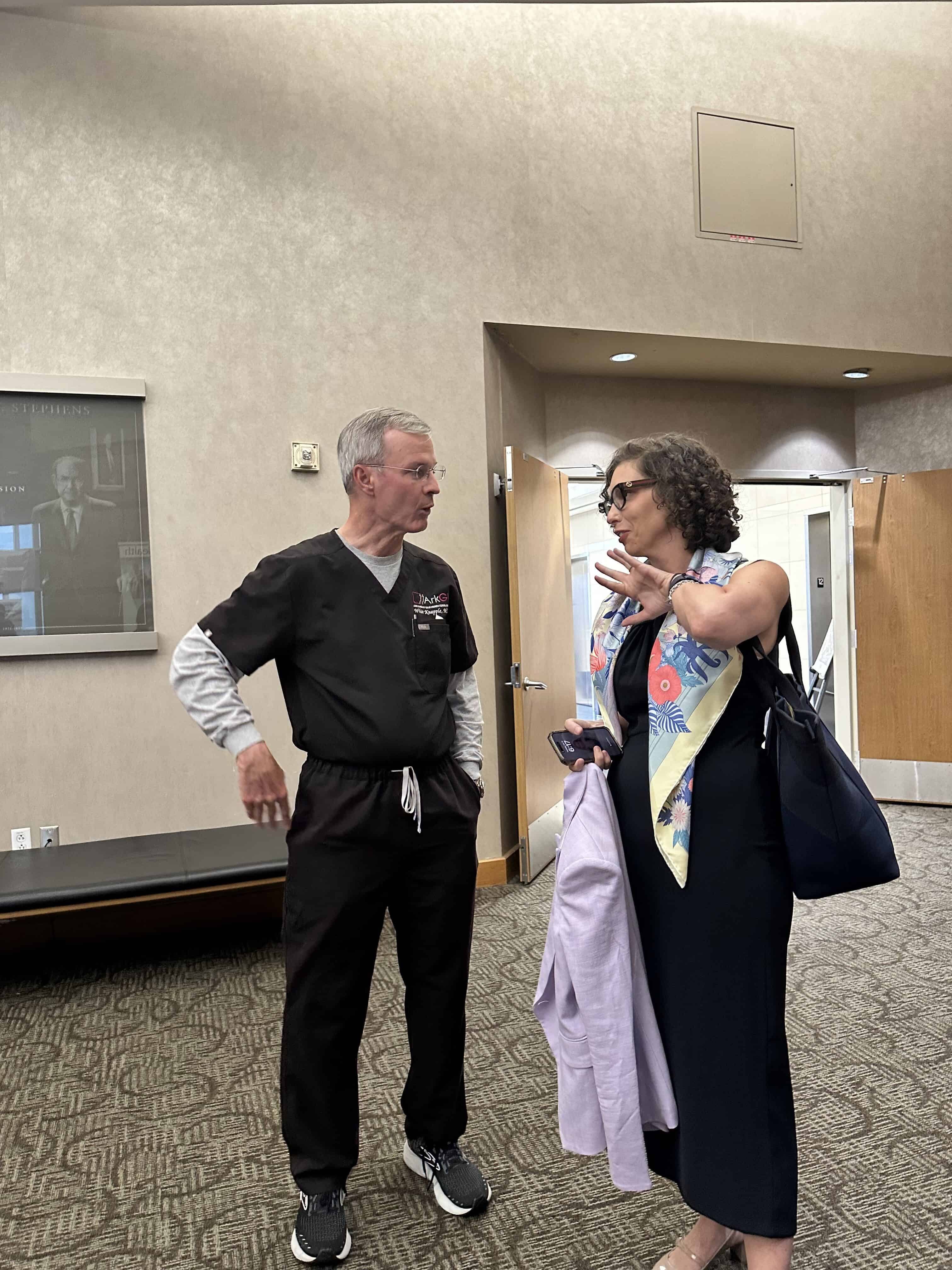 Gut Club speaker talks to a faculty member