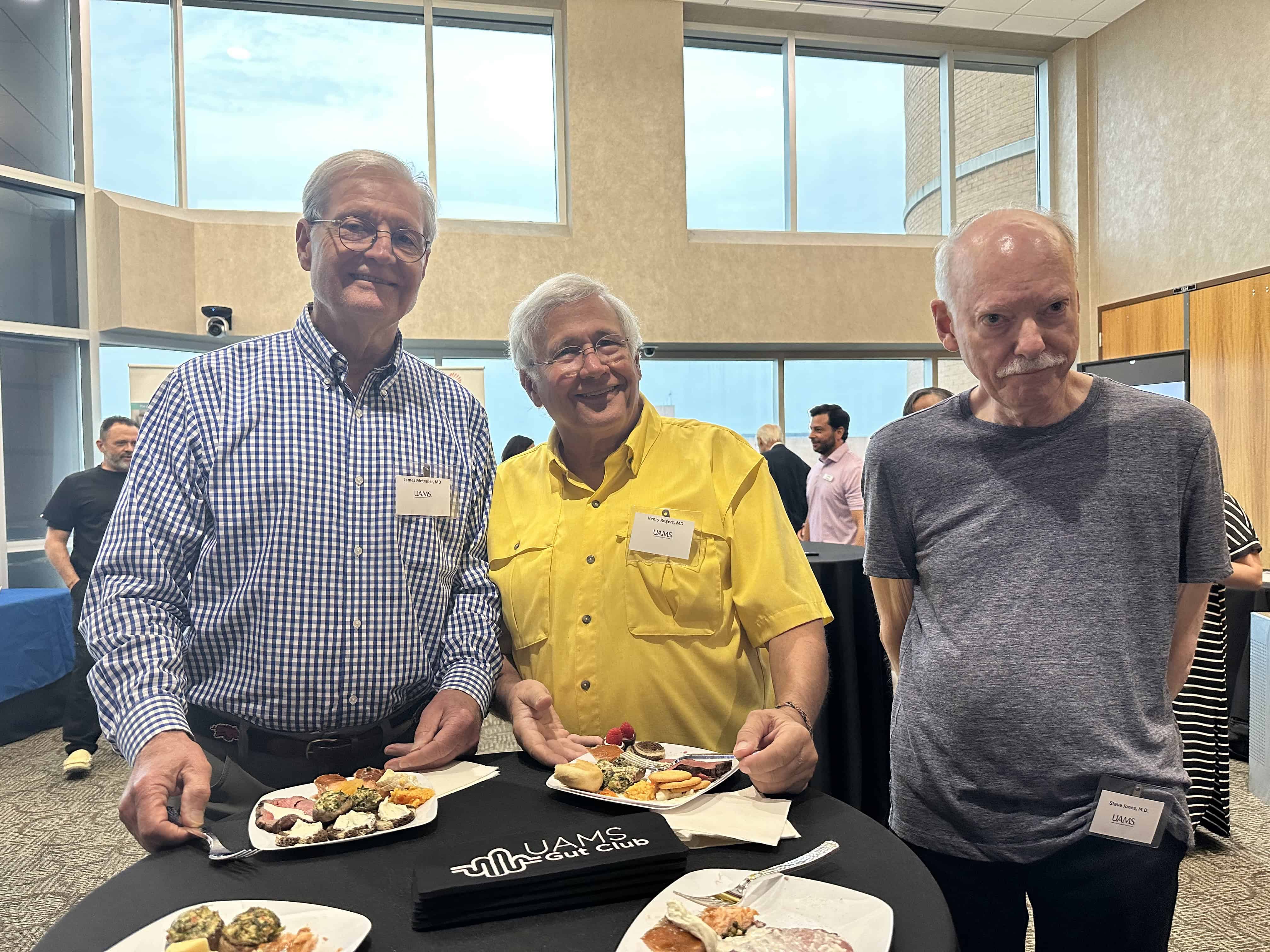 Three people posing at the Gut Club event