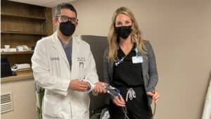 Subhi Al'Aref, M.D., and Malley Bailey hold the Alpha Vac device.