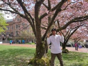 Shubham Biyani posing by a tree