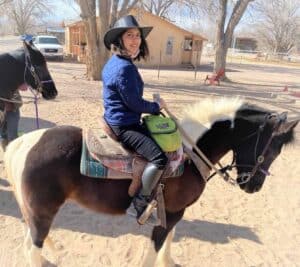 Syeda Busmah Owais riding a pony