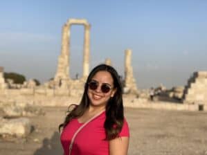 Sama Almasri posing in front of ancient ruins