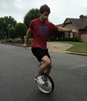 Ethan Echols riding a unicycle