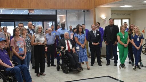 Tommy May (center) was present for the recent opening of the ALS clinic at the Northwest Regional Campus in Fayetteville. Image by David Wise