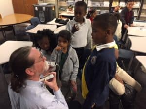 Dr. Phelan showing ultrasound unit to elementary students