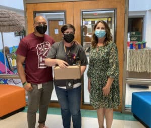 Three teachers holding boxes of infrared imaging devices