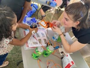 AR Tech Dash volunteer working with a child at a community event