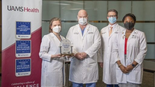 Pictured with the award, left to right: Erika Petersen, M.D., neurosurgeon; John Day, M.D., chair of the Department of Neurosurgery; Viktoras Palys, M.D., neurosurgeon; and Ebonye Green, APRN, Department of Neurosurgery. Not pictured: Analiz Rodriguez, M.D., neurosurgeon