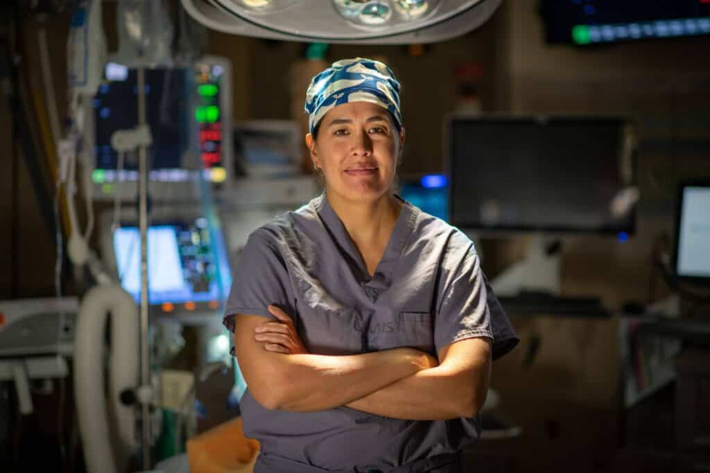 Dr. Sasaki-Adam posing in an operating room