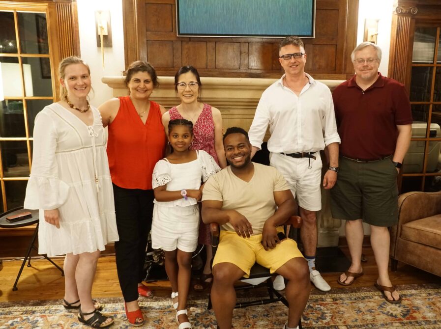 faculty posing with Marcus Stephens