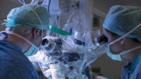 Surgeons using a robot in surgery