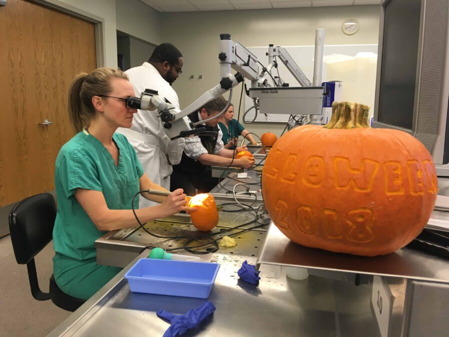 Residents working on carving pumpkins