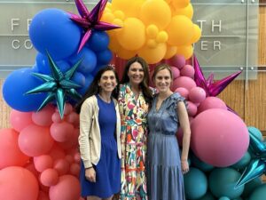 UAMS Faculty members posing in front of a large balloon installment.