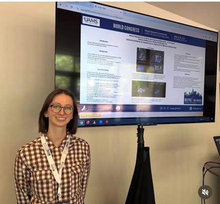 A student presenting her research displayed  on a monitor