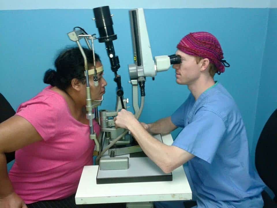 resident doing an eye exam on a woman