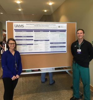 residents posing in front of a poster presentation