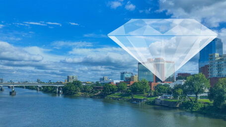 Large diamond graphic superimposed over the downtown Little Rock skyline