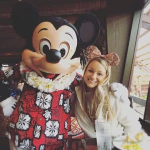 Woman posing with Mickey Mouse