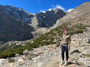 Miki Lindsey posing outdoors in a mountainous environment