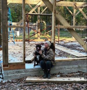 Dr. Hart with a dog at a construction site