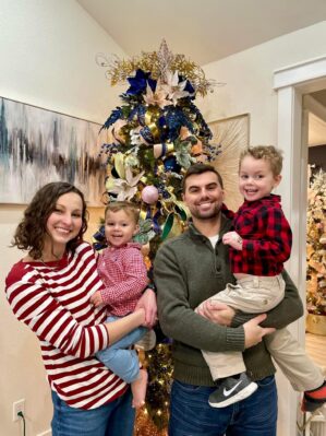 Logan Meurer with family in front of a Christmas tree