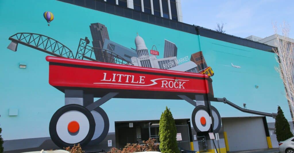 A mural of a red wagon loaded with iconic features of Little Rock