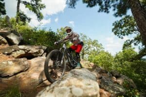 A rider prepares to drop in on a mountain bike trail at Pinnacle Mountain