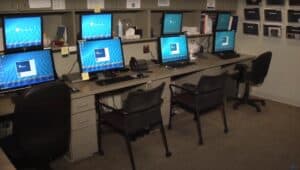 The sleep disorders lab control room consists of several work stations with computers and double monitors for tracking patient's vitals and sleep patterns