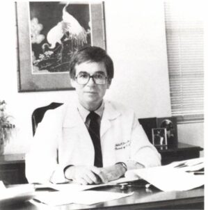 Robert H. Fiser, M.D. at his desk