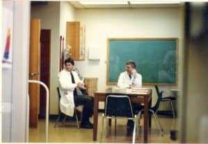 Dr. Robert Warren and a colleague having a conversation in a classroom